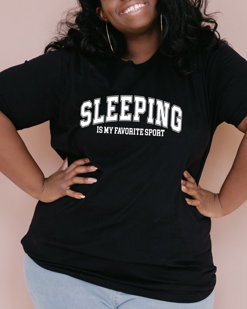 Front of a model wearing a size XL Sleeping Is My Favorite Sport in Black by Simply Sage Market. | dia_product_style_image_id:281254